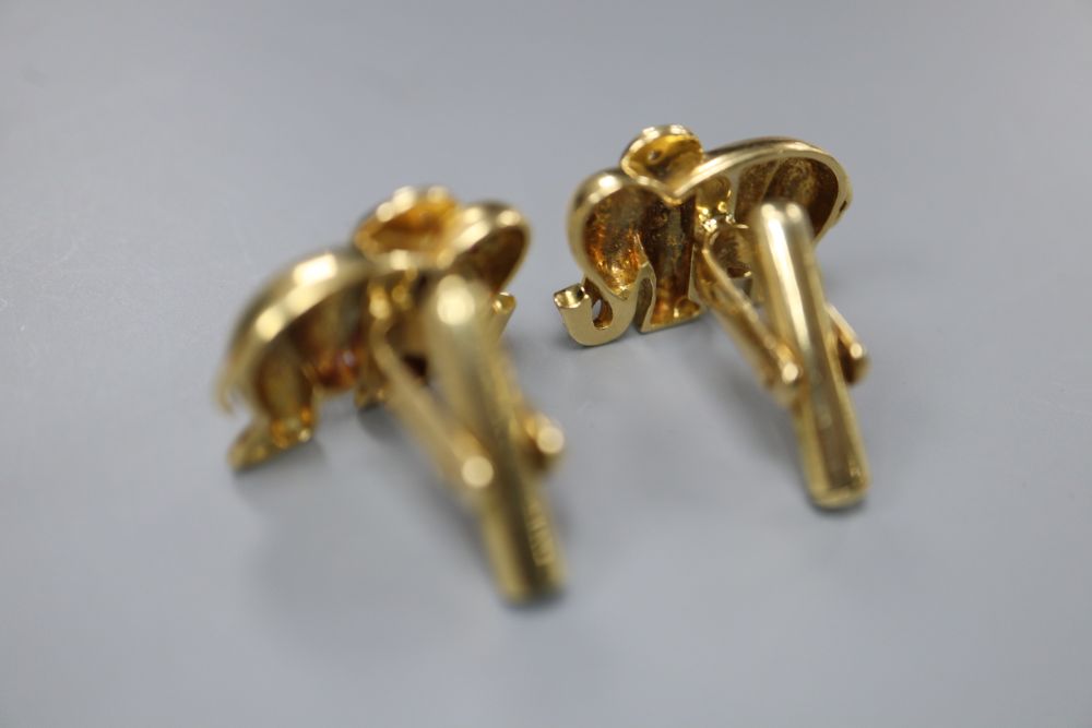 A pair of modern yellow metal (stamped 750), diamond and cabochon ruby set elephant cufflinks, 20mm, gross 14 grams.